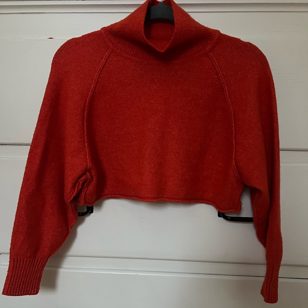 UO crop sweater in red-orange color